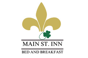A gold fleur-de-lis with a green leaf on a brown horizontal line.